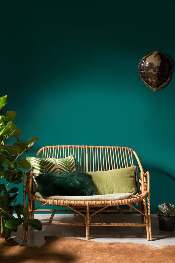 A backdrop of deep emerald green wall sets the tone for an elegant space paired with rattan double bench seat and styled with some cushions and decor. #rattanbenchseat #rattanfurniture #rattanseat #rattanstyling #rattanchair @chloedominik