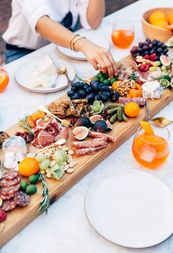 Grazing Board - 9 Essentials For Hosting The Perfect Garden Party: A grazing board is a great idea for food for your guests. Easy to prepare, doubles as a table decor piece to when your guest first arrive as well as being edible @chloedominik #outdoortabledecor #gardenparty #gardenpartyideas #gardenpartydecor #hostingagardenparty #gardenpartyessentials #grazingboard #gardenpartyfood