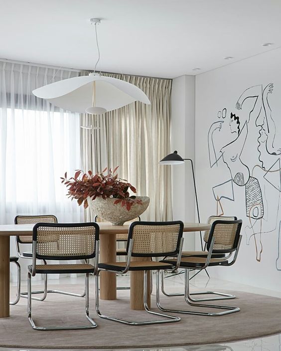 Contemporary Neutral Dining Room - July Pinterest 2020: Top 15 Inspiration & Ideas: A beautiful neutral toned dining room featuring a painted wall mural on the back wall with modern furniture and lighting to complete the designer look by interior designer Alicia Holgar. @chloedominik #contemporarydiningroom #diningroomdesign #diningroomideas #wallmuralideas #wallmuralspainted #neutraldiningroom