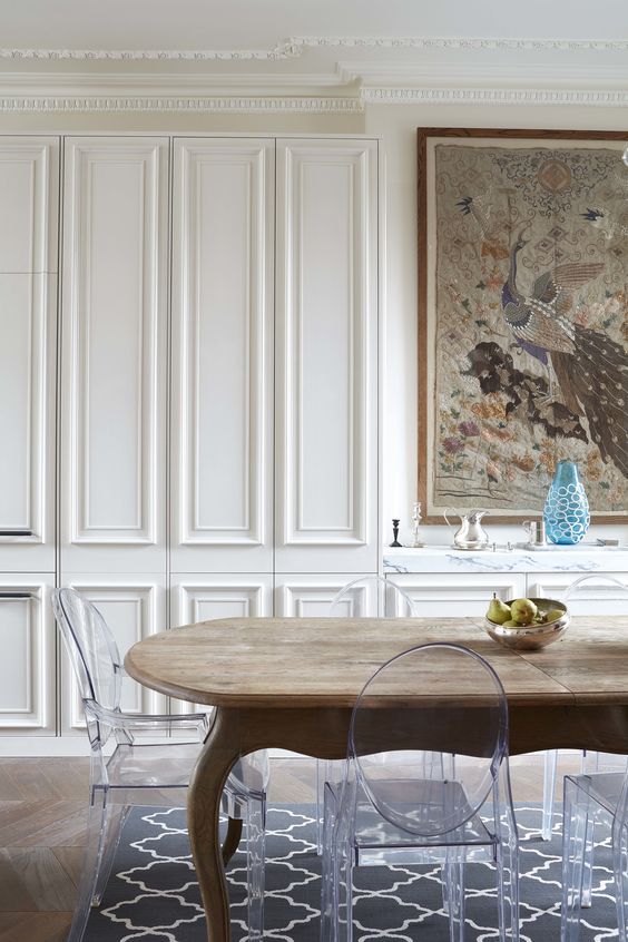 Traditional Panelled Dining Room - 17 Interiors That Will Make You Fall in Love With Panelled Walls - A dining room has made use of the wall space by using it as floor to ceiling storage and hidden it using a traditional style of panelling for the doors that work with the design interior. @chloedominik #panelledwalls #panelwalls #panelledinteriors #panelledinteriorwalls #panelwallideas #panelwalldesigns #panelwallstorage #panelwalldiningroom