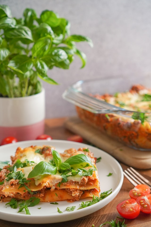 lasagne dish topped with basil herb