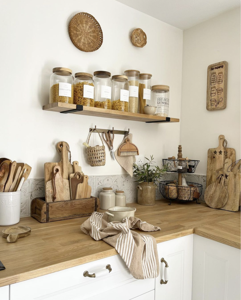 Kitchen No Uppers:
Beautiful styled cottage kitchen with floating shelf and mini peg rail used for styling and storing kitchen items. Rattan and wooden accents decorate the wall. 
Photo credit: Nathalie from lamaisondethalie Instagram profile