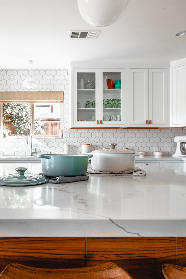 marble vs quartz countertops pots on tea towels on kitchen island countertop